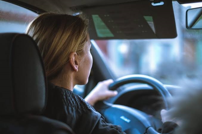 New UK driver holding a full driving licence with information about penalty points, driving rules and licence restrictions in 2026